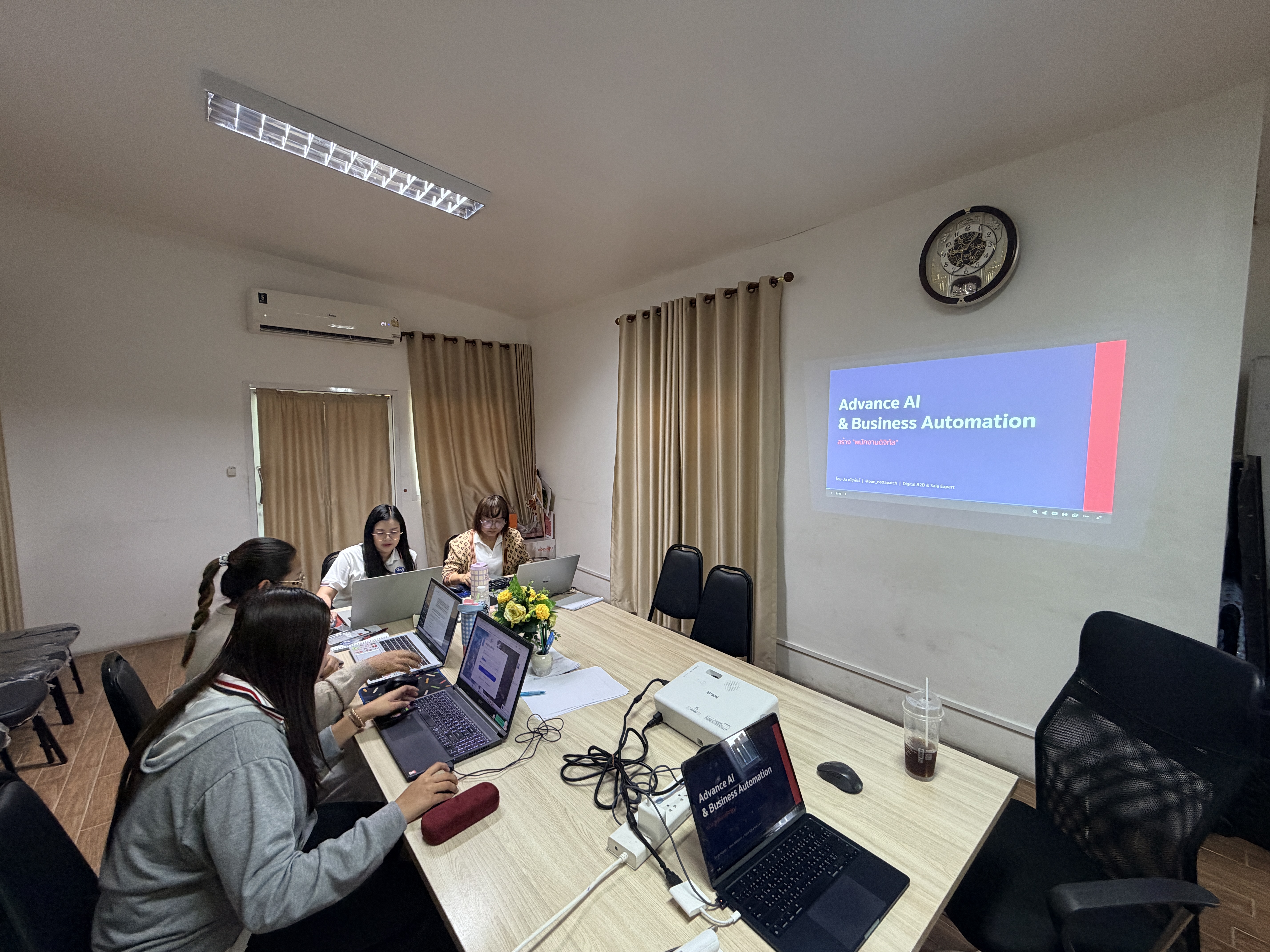 ทีมใช้ laptop ในห้อง workshop · จอฉาย "Advance AI & Business Automation"